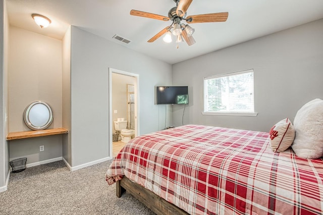 carpeted bedroom with visible vents, a ceiling fan, baseboards, and ensuite bathroom