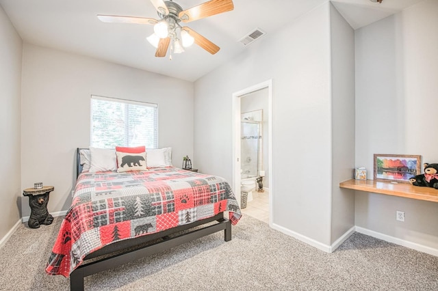 carpeted bedroom with ceiling fan, built in study area, ensuite bath, baseboards, and visible vents