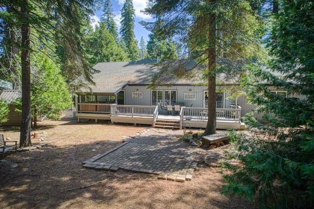 back of house with a wooden deck