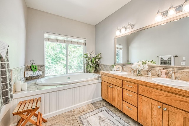 bathroom featuring a sink, double vanity, and a bath