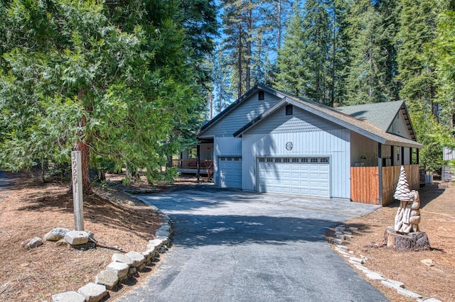 view of property exterior with a garage and aphalt driveway