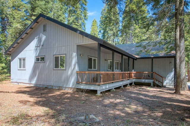 back of house featuring a wooden deck
