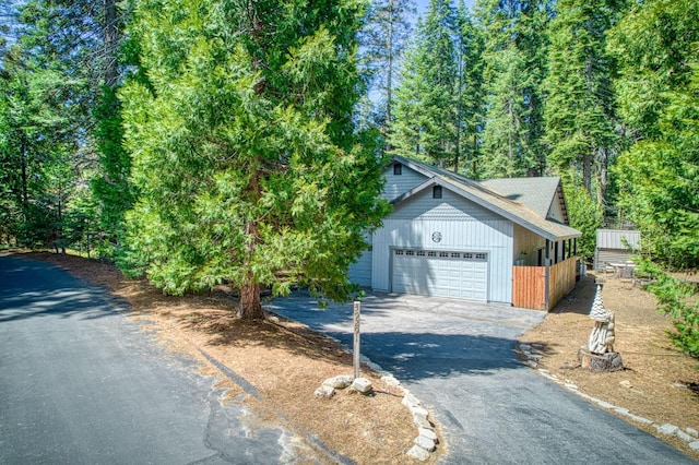 view of front of home featuring an attached garage and aphalt driveway