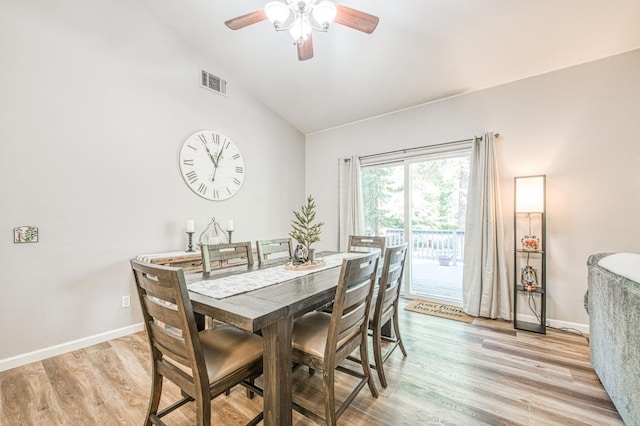 dining room featuring a ceiling fan, baseboards, vaulted ceiling, light wood-type flooring, and visible vents