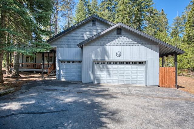 garage featuring covered porch and driveway