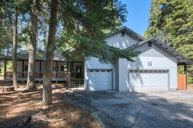 exterior space with a porch and a detached garage