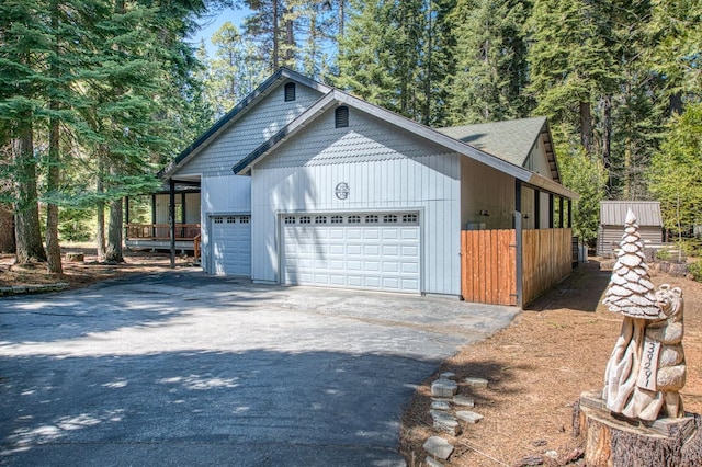 view of home's exterior featuring a garage and aphalt driveway
