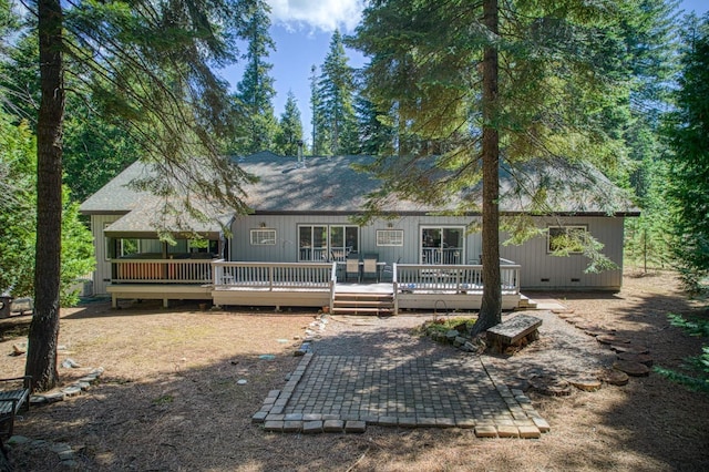 rear view of property featuring a patio and a deck