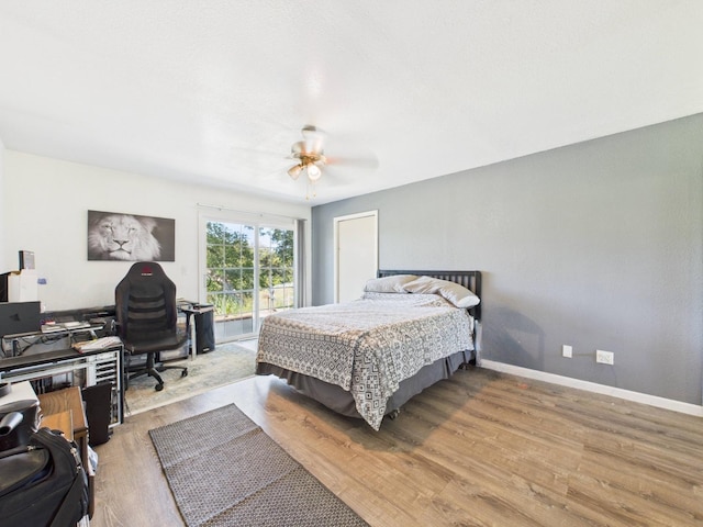 bedroom featuring baseboards, ceiling fan, and wood finished floors
