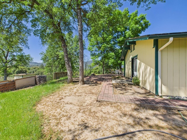 view of yard with fence and a patio