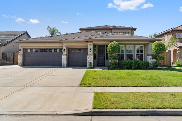 1389 Vineyard Pl, Hanford, CA 93230 - prairie-style home featuring a tile roof, a garage, stucco siding, a front yard, and concrete driveway