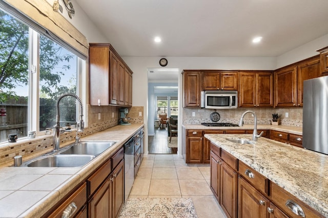 1389 Vineyard Pl, Hanford, CA 93230 - kitchen with backsplash, light tile patterned flooring, appliances with stainless steel finishes, and a sink