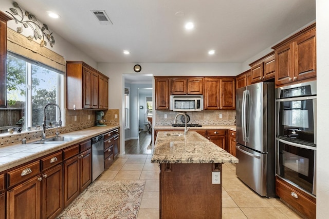 1389 Vineyard Pl, Hanford, CA 93230 - kitchen with a sink, appliances with stainless steel finishes, backsplash, and visible vents