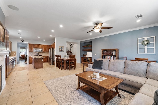 1389 Vineyard Pl, Hanford, CA 93230 - living area with ceiling fan, visible vents, light tile patterned floors, a glass covered fireplace, and stairs