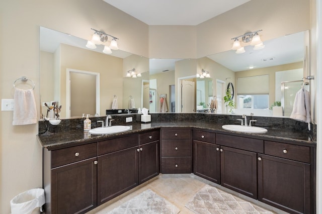 full bathroom featuring a sink, tile patterned floors, and double vanity