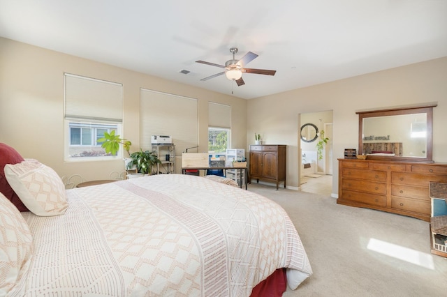 bedroom featuring ceiling fan, visible vents, and light carpet