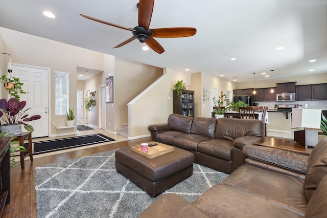 living room with stairs, wood finished floors, baseboards, recessed lighting, and a ceiling fan