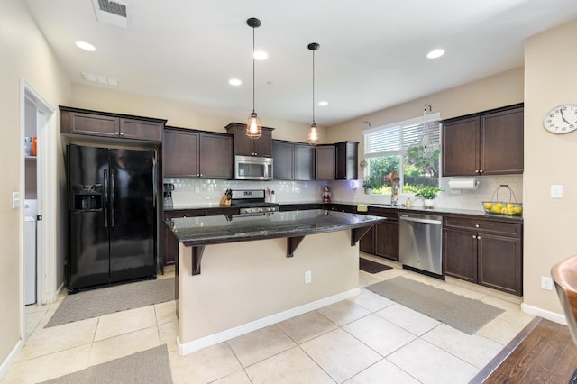 kitchen with dark brown cabinets, stainless steel appliances, and visible vents