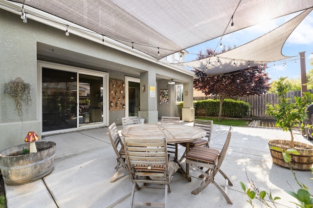 view of patio with fence and outdoor dining space