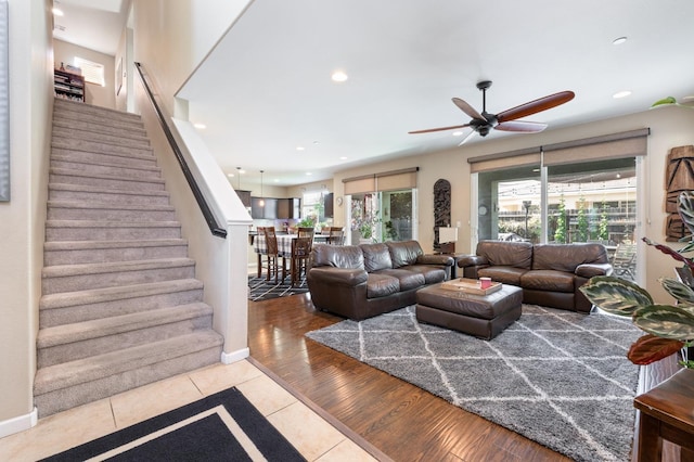 living room with ceiling fan, tile patterned flooring, stairs, recessed lighting, and baseboards