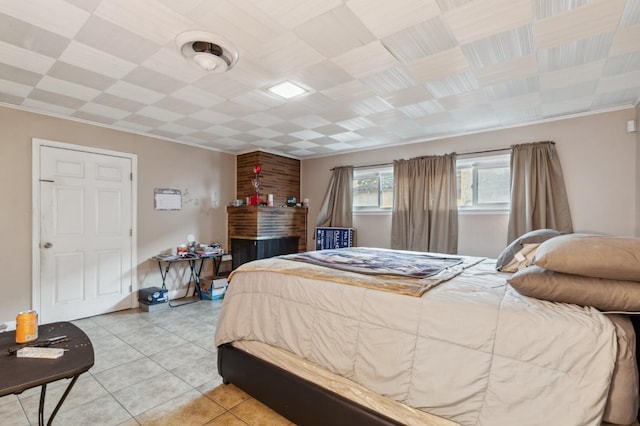 bedroom with crown molding and light tile patterned floors