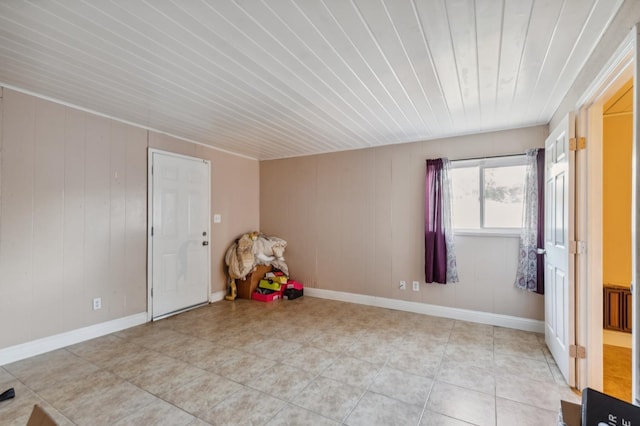 recreation room featuring wooden ceiling, baseboards, and light tile patterned flooring