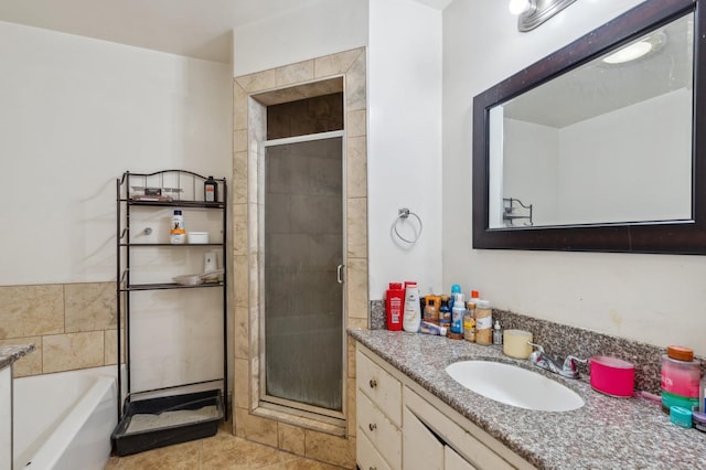 bathroom featuring vanity, a garden tub, a stall shower, and tile patterned flooring