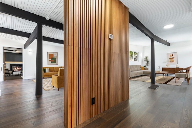 hall featuring ornate columns, beam ceiling, and hardwood / wood-style flooring