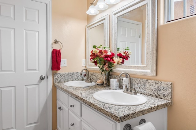 bathroom featuring double vanity and a sink