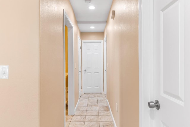 hallway featuring recessed lighting and baseboards