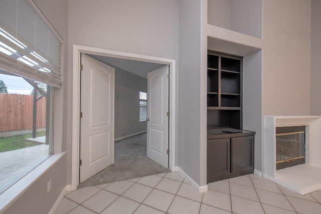 7224 N Bonadelle Ave, Fresno, CA 93720 - interior space featuring baseboards, light carpet, a wealth of natural light, and built in shelves