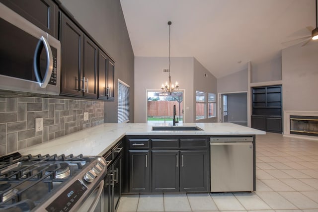7224 N Bonadelle Ave, Fresno, CA 93720 - kitchen featuring appliances with stainless steel finishes, a sink, high vaulted ceiling, a peninsula, and decorative backsplash