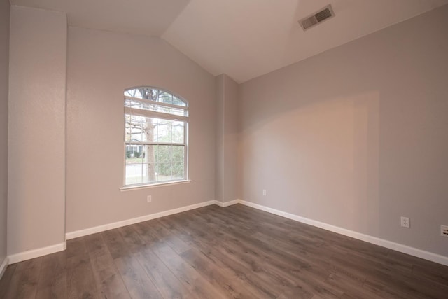 7224 N Bonadelle Ave, Fresno, CA 93720 - empty room with baseboards, visible vents, vaulted ceiling, and dark wood-type flooring