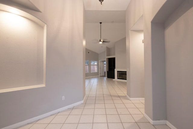 7224 N Bonadelle Ave, Fresno, CA 93720 - corridor featuring baseboards, light tile patterned floors, and high vaulted ceiling