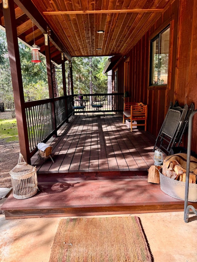 wooden terrace with a porch