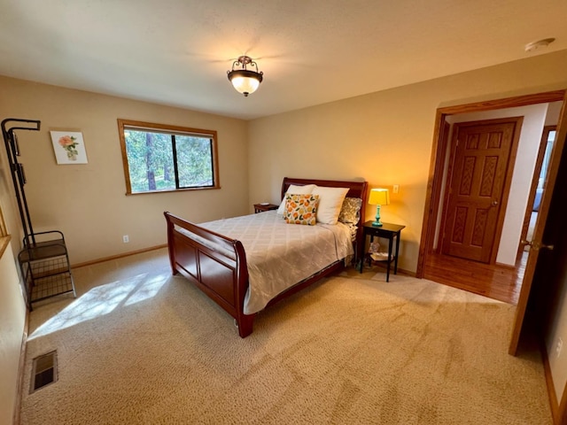 bedroom with baseboards, carpet, and visible vents