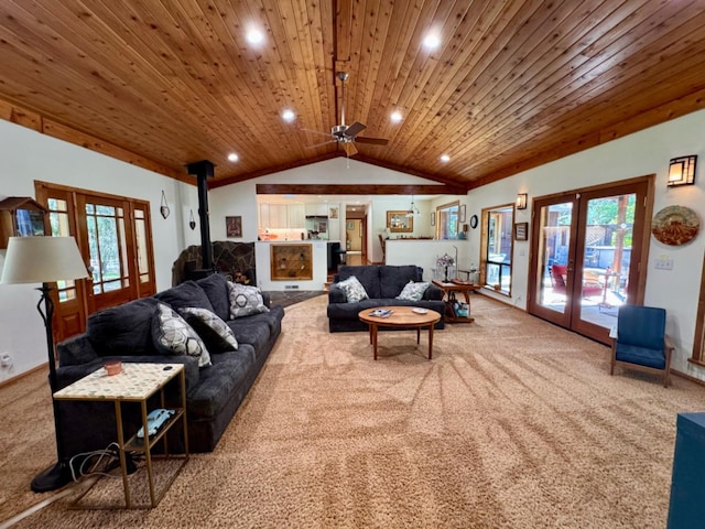 living area with french doors, a wood stove, wooden ceiling, carpet floors, and lofted ceiling