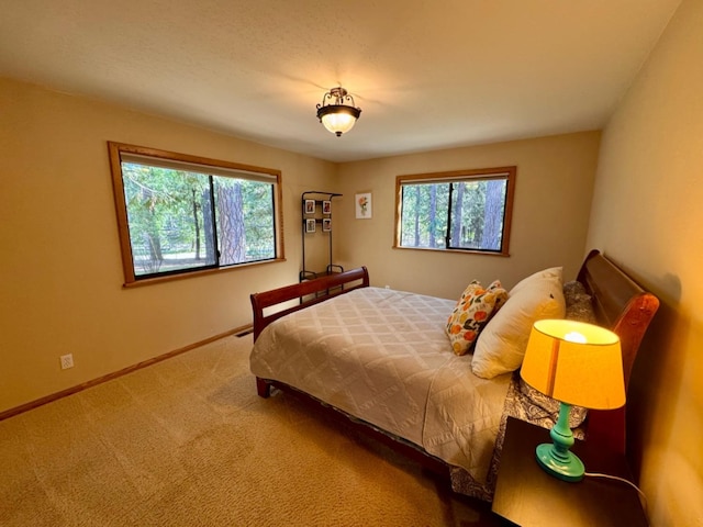 carpeted bedroom with baseboards