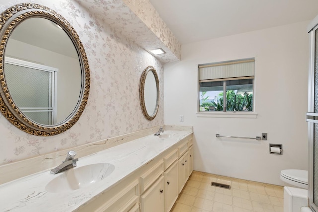 full bathroom with a sink, double vanity, toilet, tile patterned floors, and visible vents