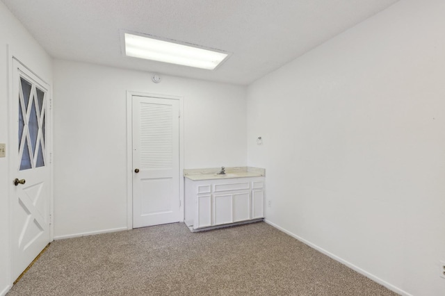 empty room with light colored carpet and baseboards