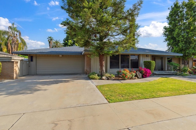 single story home with concrete driveway, board and batten siding, a front yard, and a garage