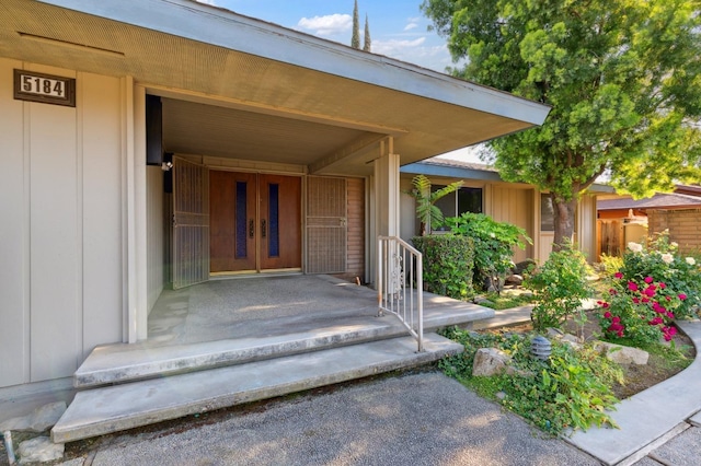 view of exterior entry with board and batten siding