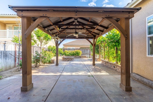 exterior space with fence, a patio, a gazebo, and an outdoor fire pit