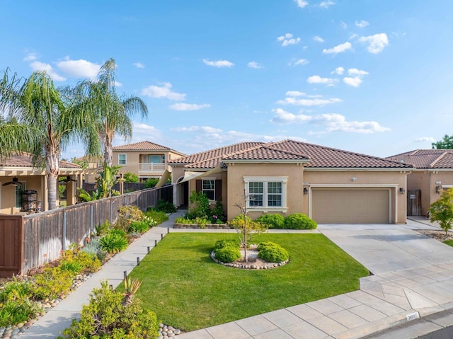 mediterranean / spanish home with stucco siding, an attached garage, fence, and a tiled roof