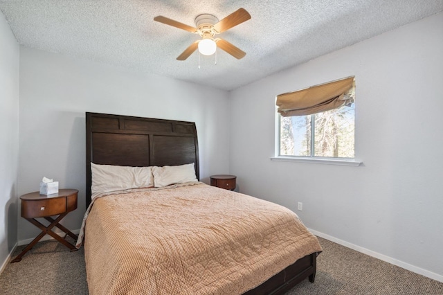 bedroom with baseboards, carpet flooring, and a textured ceiling