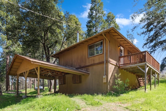 view of side of home with a carport, stairs, and a deck