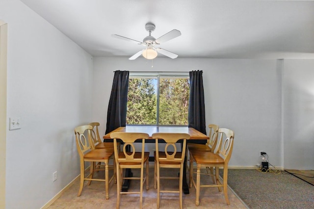dining room with ceiling fan and baseboards
