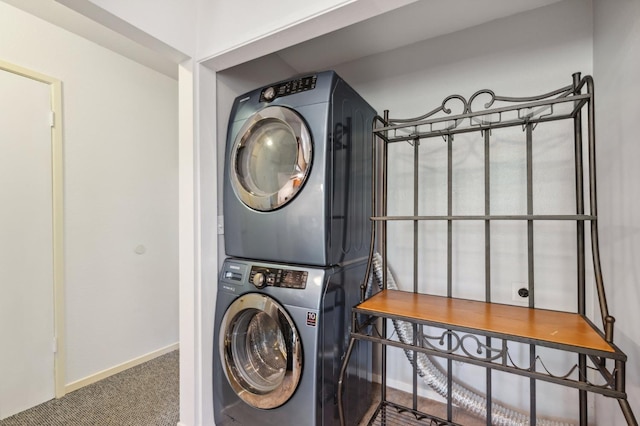 laundry area featuring laundry area, baseboards, carpet floors, and stacked washer / dryer