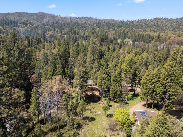 birds eye view of property featuring a view of trees