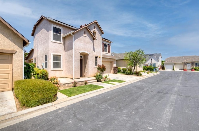 619 W Casanova Ln, Clovis, CA 93619 - view of front facade with a residential view, stucco siding, and concrete driveway